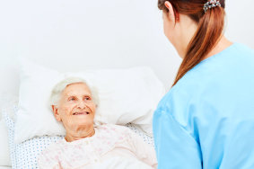 caregiver taking care of old woman