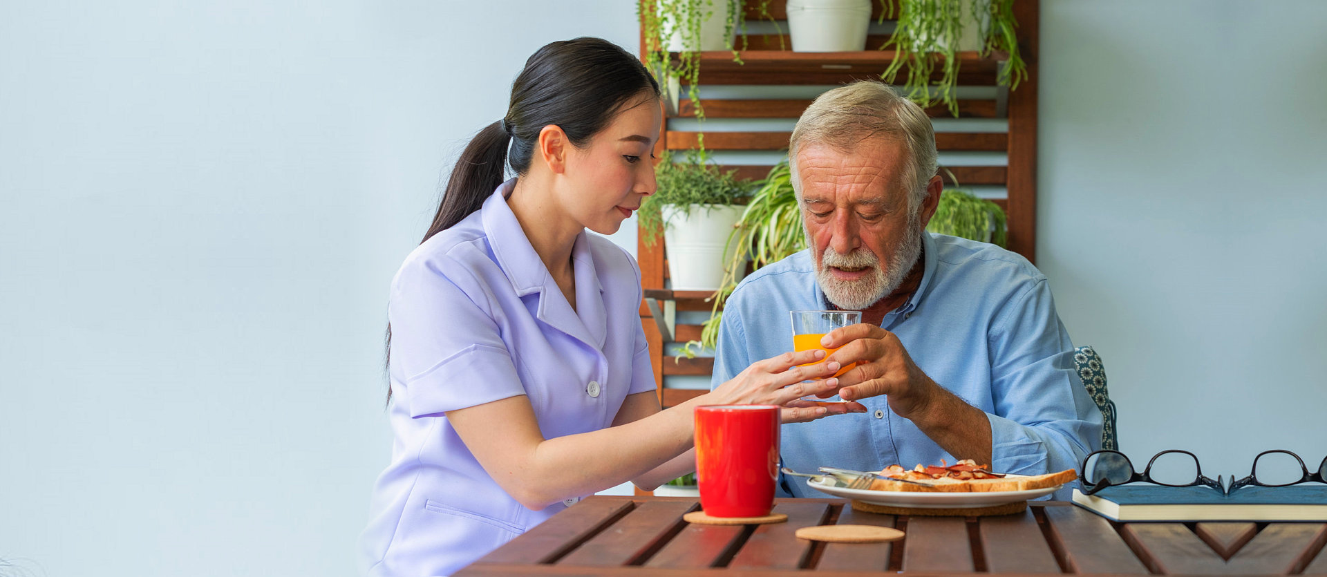 caregiver assisting old man in eating