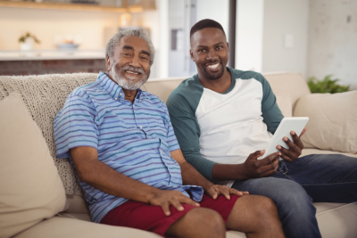 adult man and senior man smiling